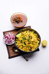 Aloo/Kanda Poha or Tarri Pohe with spicy chana masala/curry. selective focus
