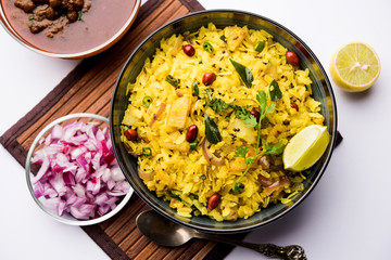 Aloo/Kanda Poha or Tarri Pohe with spicy chana masala/curry. selective focus