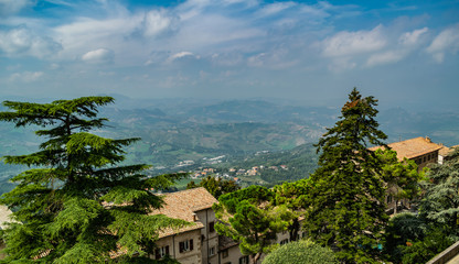 View on the hilly plain of the foothills of the Apennines and roofs of old houses from the mountain  Monte Titano, old city of republic of san marino