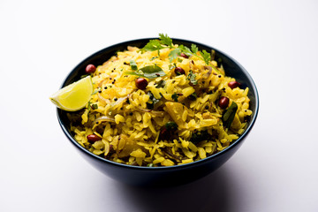 Aloo/Kanda Poha or Tarri Pohe with spicy chana masala/curry. selective focus