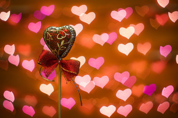 Souvenir in the shape of a heart on the background of holiday lights. Valentine's day.