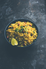 Aloo/Kanda Poha or Tarri Pohe with spicy chana masala/curry. selective focus