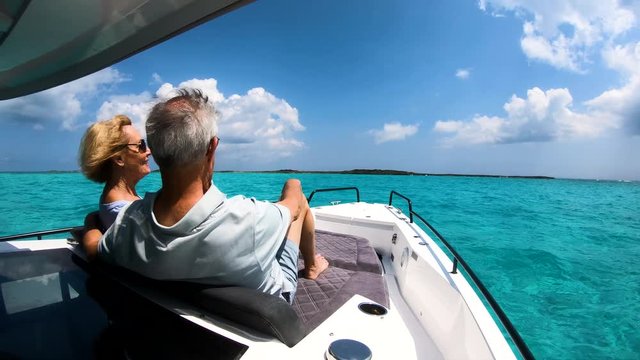 Carefree male and female seniors on sailboat Bahamas