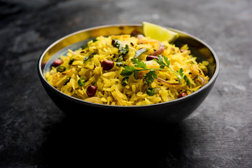 Aloo/Kanda Poha or Tarri Pohe with spicy chana masala/curry. selective focus