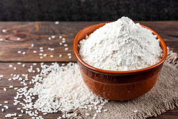 Rice flour on wooden background.