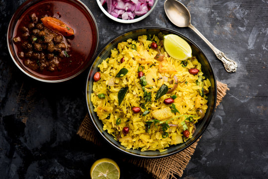 Aloo/Kanda Poha or Tarri Pohe with spicy chana masala/curry. selective focus