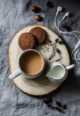 Coffee break - coffee and chocolate cookies on grey background, top view. Cozy home still life