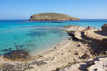 Fototapeta na wymiar Beautiful sandy Cala Comte beach with azure blue sea water, Ibiza island, Spain