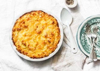 Chicken, bacon and leek cottage pie on a light background,top view