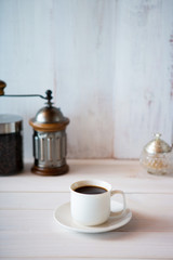 cup of coffee and beans on white background