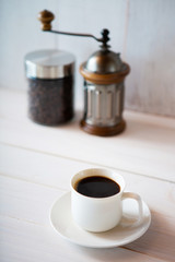 cup of coffee and beans on white background