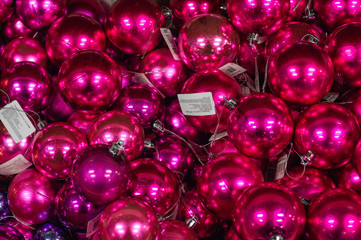 Sale of Christmas toys in the supermarket. Balls of different colors for the Christmas tree on the supermarket shelves. 