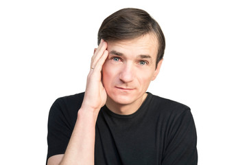 Fototapeta premium A man holds his head with a sad face on a white background. A man has a headache and he has a red, sick eye on conjunctivitis