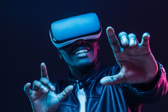 Fototapeta African man wearing virtual reality headset having great fun