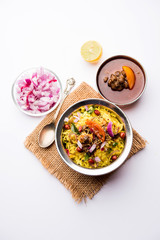 Aloo/Kanda Poha or Tarri Pohe with spicy chana masala/curry. selective focus