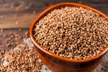 Buckwheat on wooden background.