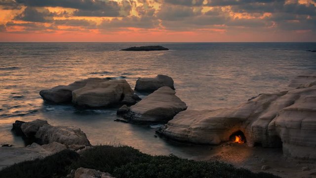 Cinemagraph sunset seascape with bonfire