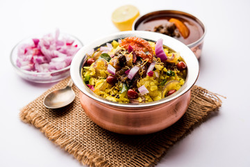 Aloo/Kanda Poha or Tarri Pohe with spicy chana masala/curry. selective focus
