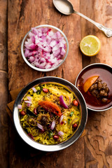 Aloo/Kanda Poha or Tarri Pohe with spicy chana masala/curry. selective focus