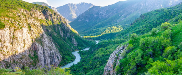 Fototapeta na wymiar Panoramic view of the sunset in a green valley