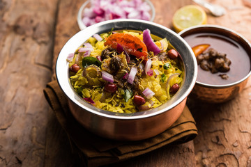 Aloo/Kanda Poha or Tarri Pohe with spicy chana masala/curry. selective focus