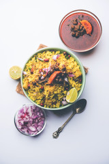 Aloo/Kanda Poha or Tarri Pohe with spicy chana masala/curry. selective focus
