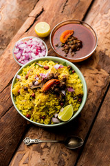 Aloo/Kanda Poha or Tarri Pohe with spicy chana masala/curry. selective focus