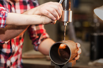 good father took his little son to work with metal. Concept of relationship, child at work turner