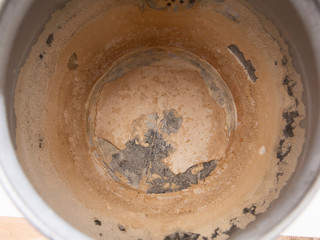 Limescale, scale in old kettle. A white, chalky residue from deposit of calcium carbonate. Hard water problem.