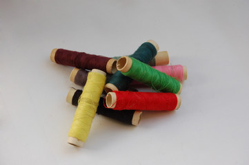 a bunch of colorful threads on the reels