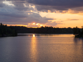sunset over a forest lake