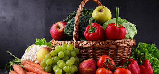 Fresh organic fruits and vegetables in wicker basket