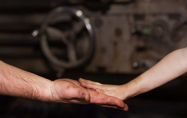 good father took his little son to work with metal. Concept of relationship, child at work turner