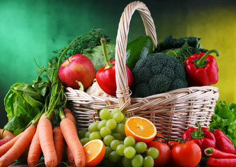 Fresh organic fruits and vegetables in wicker basket