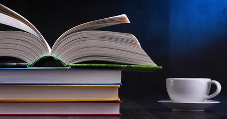 Composition with books and cup of coffee on the table