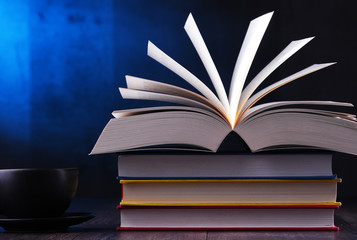 Composition with books and cup of coffee on the table