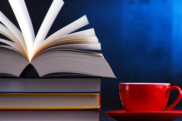 Composition with books and cup of coffee on the table