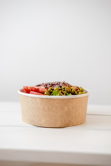 Take away salad in disposable paper bowl