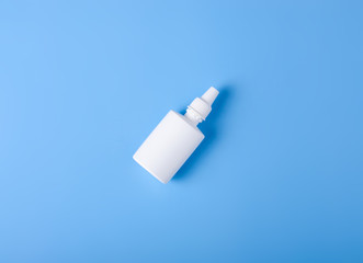 Spray for nose nasal on blue background, top view, medical pharmacy concept