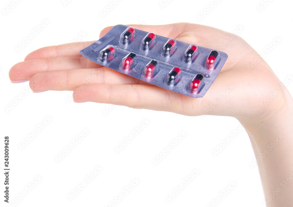 Sticker Pill capsule black red in blister in hand medicine health on white background isolation