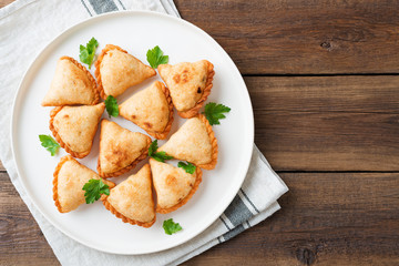 Vegetarian samosas filled with potato and green pea served with different sauces .Indian special traditional street food. 