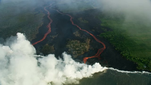 Aerial view red hot lava pouring into Pacific
