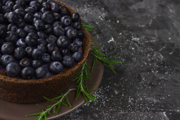 Blueberry vegan cheesecake. Dark photo on black background