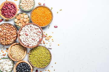 Legumes, lentils, chikpea and beans assortment on white.