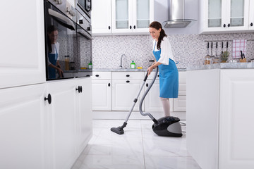 Janitor Cleaning Kitchen Floor With Vacuum Floor