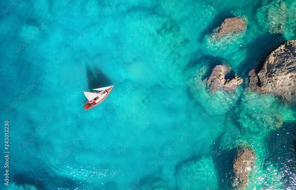 Wall mural yacht on the sea from top view. turquoise water background from top view. summer seascape from air. 