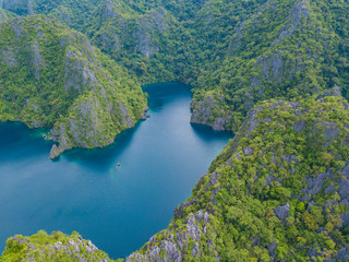 Aerial view to Barracuda lake with blue water, on a tropical island Coron. Lake in the mountains covered with tropical forest. Palawan, Philippines.