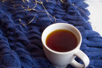 Cup of tea on knitted background. Breakfast with cookies

