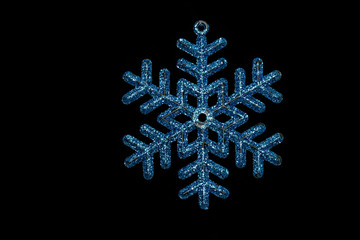 Christmas tree shining snowflake isolated on black background