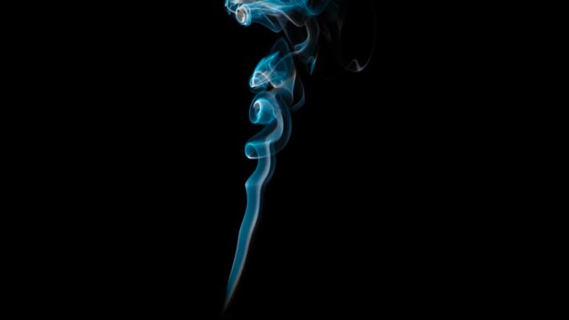 Slow Ornate Smoky Stream. The bright Blue Smoke slowly rises upward forming beautiful loops and rings that hang on a black background